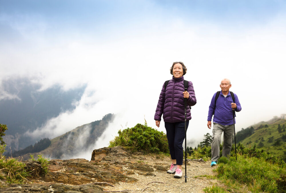 elderly couple hiking on a mountain